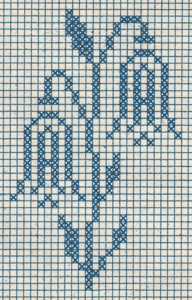 A charted cross-stitch monogram letter A on graph paper